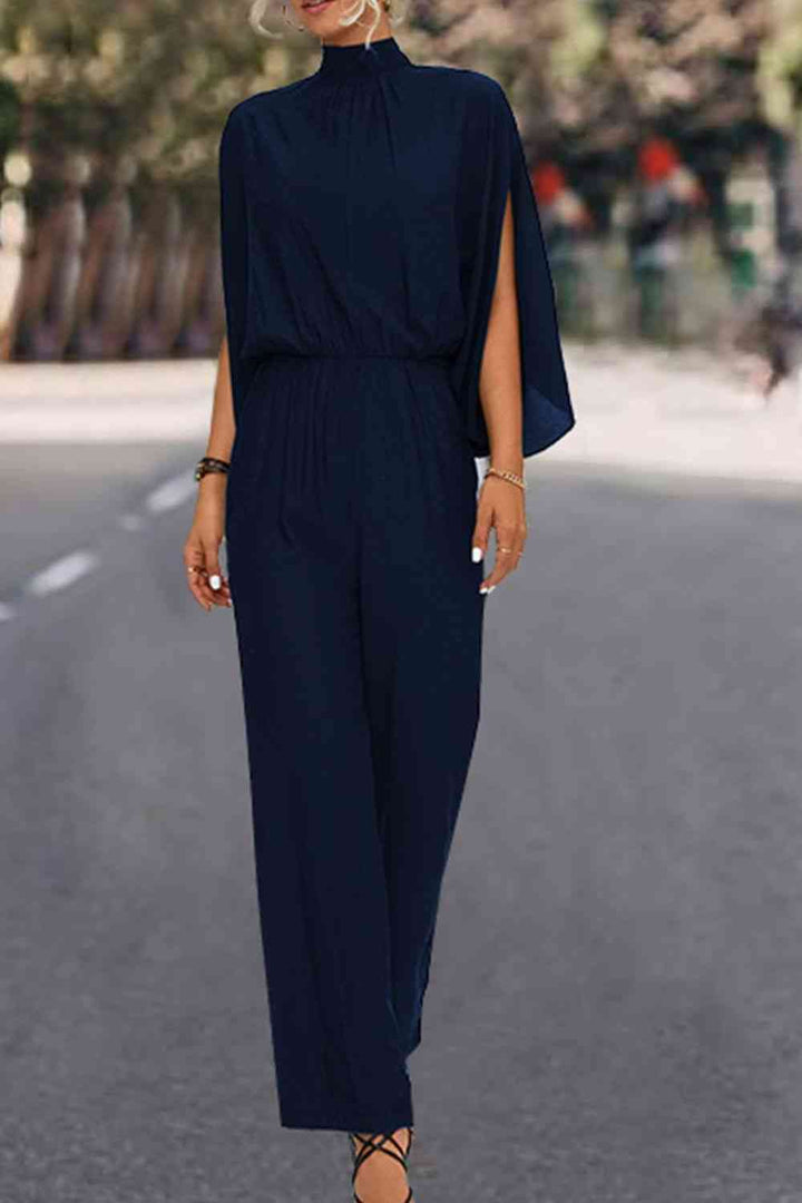 Elegante bloemenjumpsuit met hoge kraag en strikrug