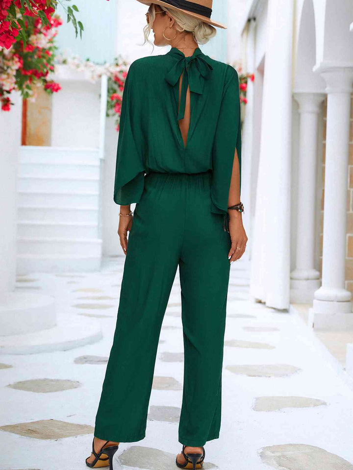 Elegante bloemenjumpsuit met hoge kraag en strikrug
